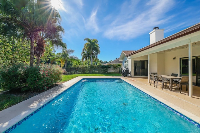 view of swimming pool with a patio and a grill