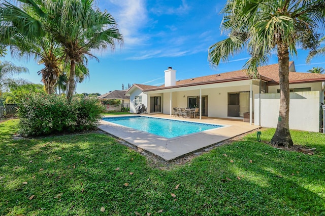 view of pool featuring a yard and a patio