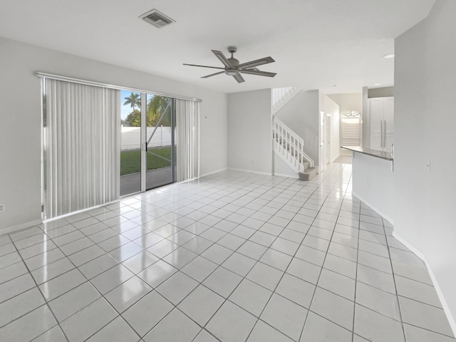 tiled empty room with ceiling fan