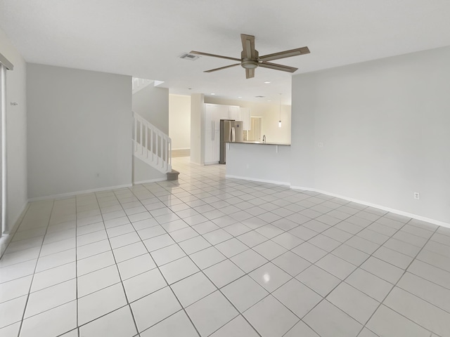 spare room featuring ceiling fan, sink, and light tile patterned floors