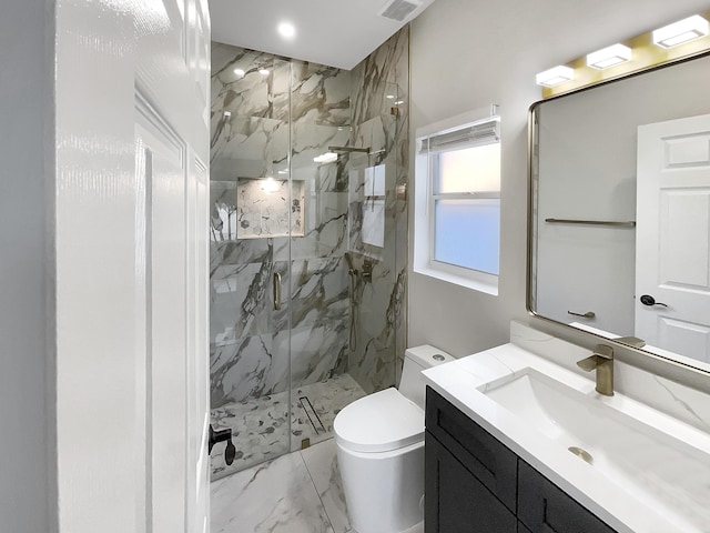 bathroom featuring vanity, toilet, and a shower with shower door