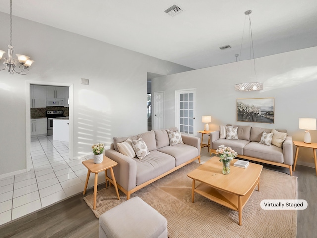 living room featuring tile patterned floors and an inviting chandelier