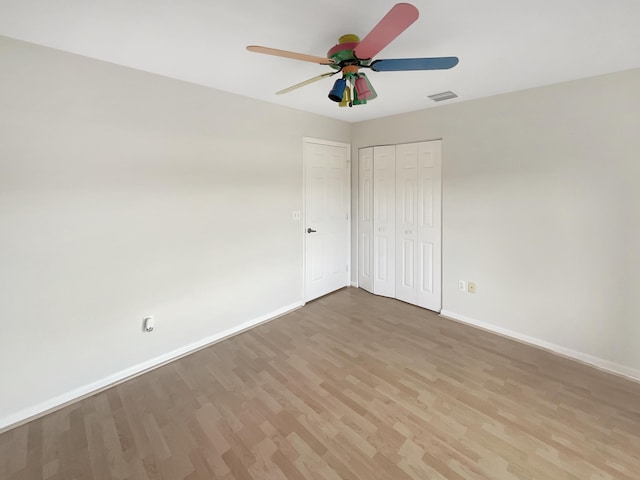 spare room with ceiling fan and light wood-type flooring