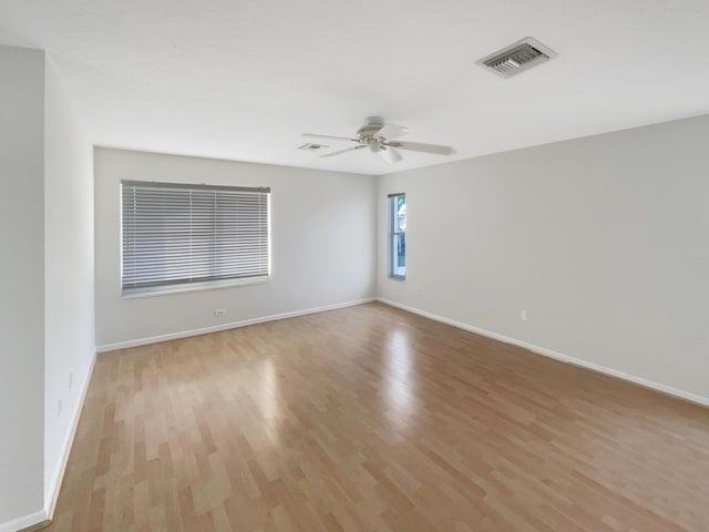 unfurnished room with light wood-type flooring and ceiling fan