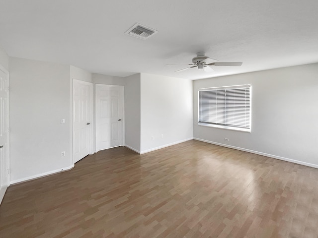 unfurnished room with ceiling fan and dark hardwood / wood-style floors