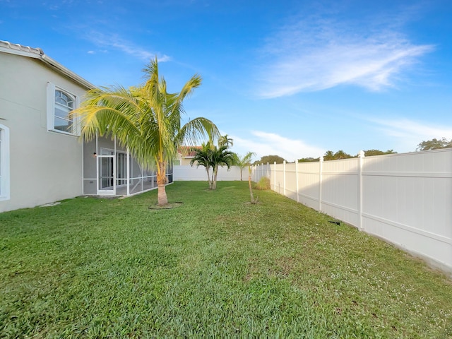 view of yard featuring a sunroom