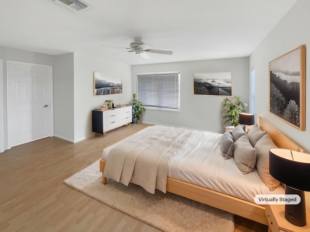 bedroom with ceiling fan and wood-type flooring