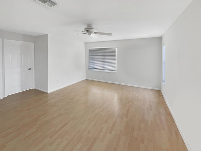 empty room featuring ceiling fan and light hardwood / wood-style floors