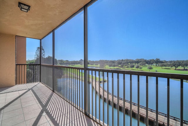 unfurnished sunroom featuring a water view