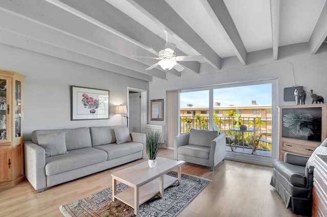 living room with beam ceiling, light hardwood / wood-style floors, and ceiling fan