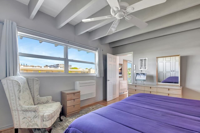 bedroom with beam ceiling, light hardwood / wood-style floors, and ceiling fan