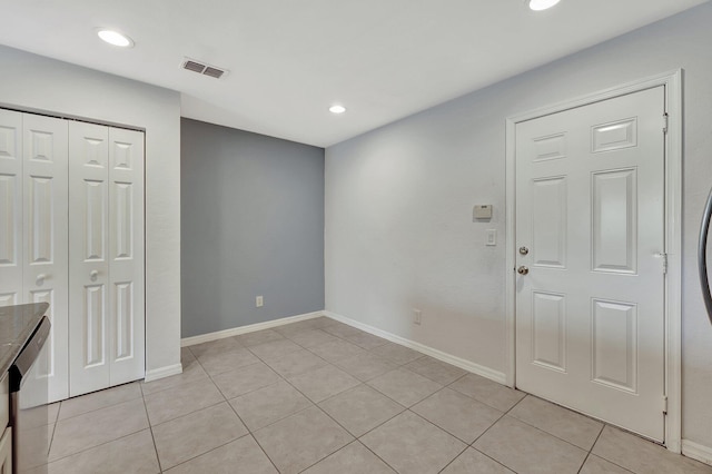 foyer entrance with light tile patterned floors