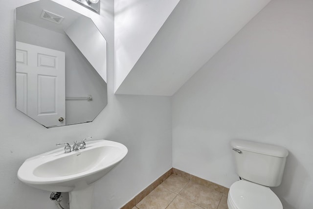 bathroom featuring tile patterned flooring, toilet, and sink