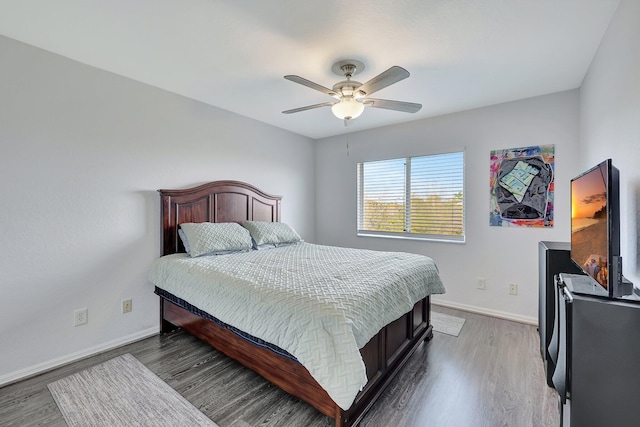 bedroom featuring ceiling fan and dark hardwood / wood-style flooring