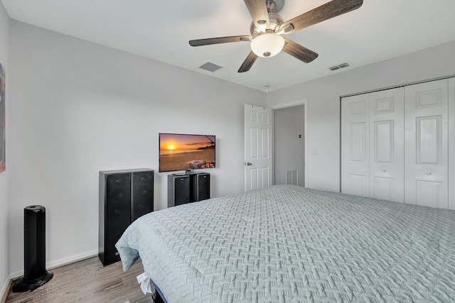 bedroom featuring ceiling fan, a closet, and light wood-type flooring