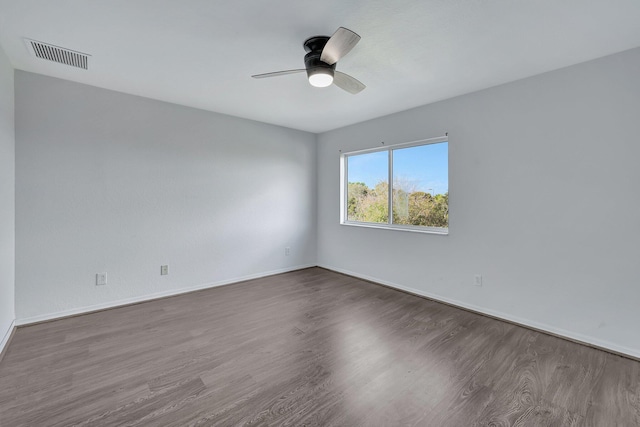 empty room with ceiling fan and hardwood / wood-style flooring