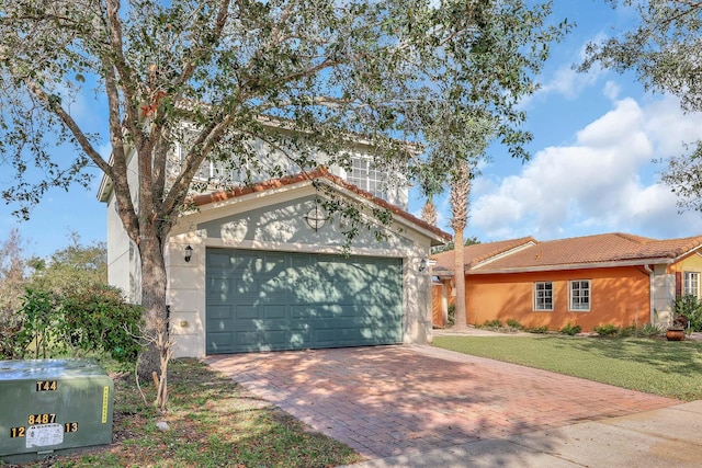 view of front of property with a garage and a front lawn