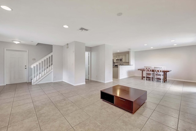 unfurnished living room featuring light tile patterned floors