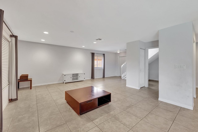 unfurnished living room featuring light tile patterned floors