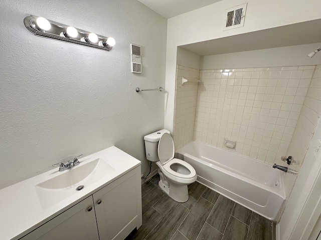 full bathroom featuring wood tiled floor, visible vents, tub / shower combination, and vanity