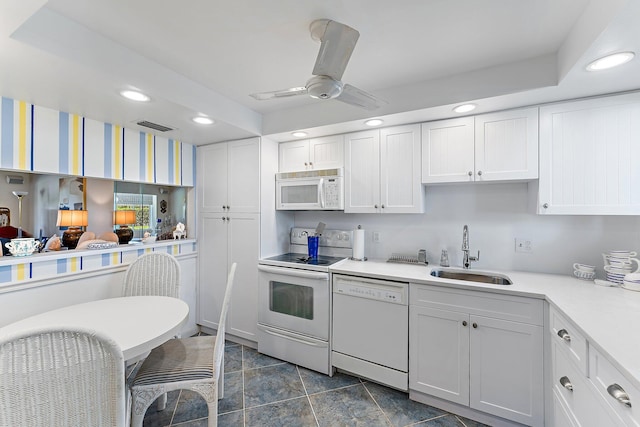 kitchen featuring ceiling fan, sink, white cabinets, and white appliances