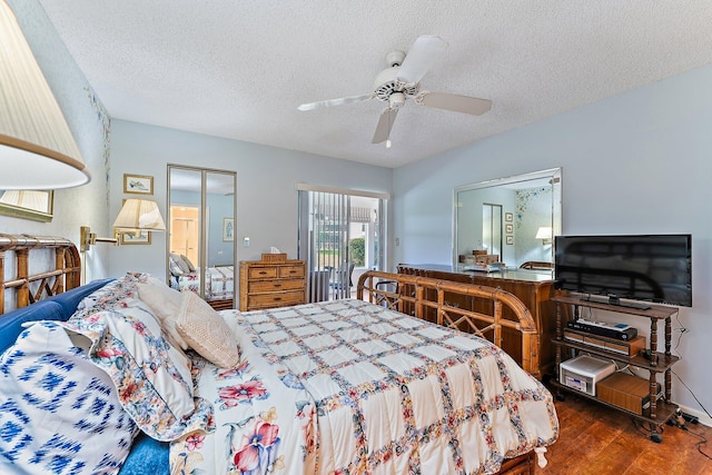 bedroom featuring hardwood / wood-style floors, ceiling fan, and a textured ceiling