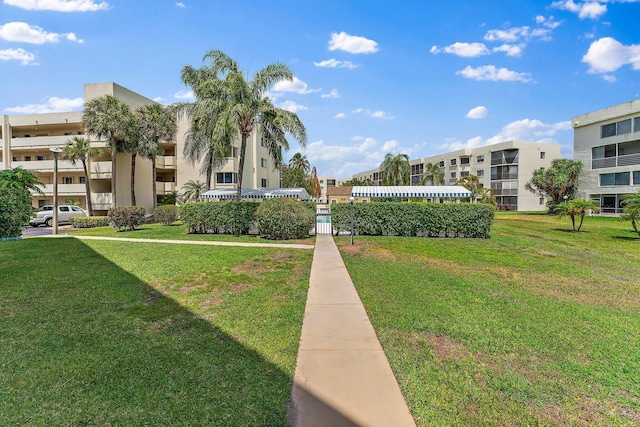 view of property's community featuring a yard