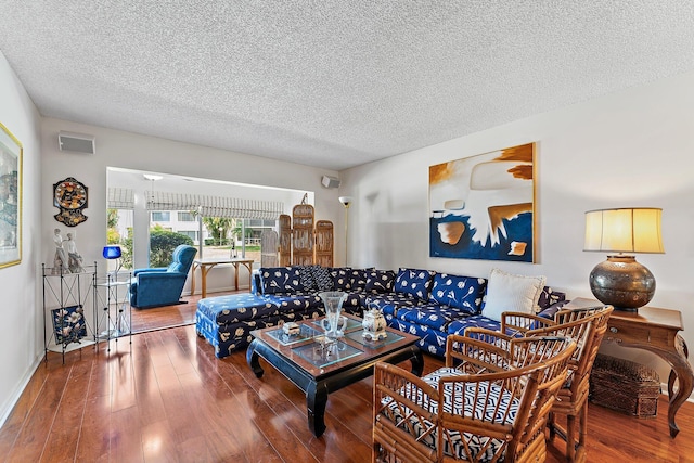 living room with hardwood / wood-style flooring and a textured ceiling