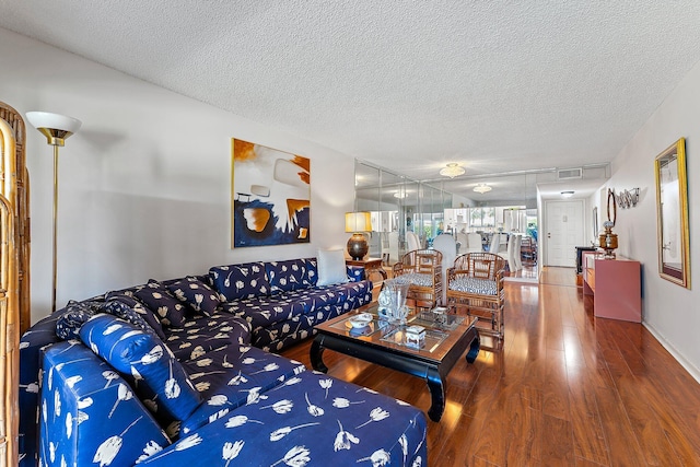 living room featuring hardwood / wood-style floors and a textured ceiling