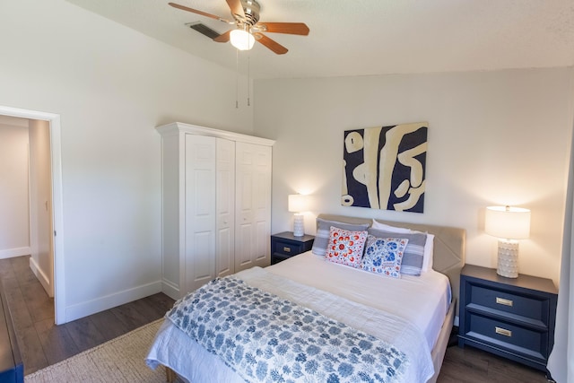 bedroom with a closet, ceiling fan, lofted ceiling, and dark hardwood / wood-style floors