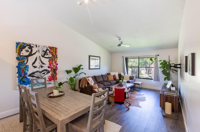 dining space with ceiling fan, wood-type flooring, and lofted ceiling