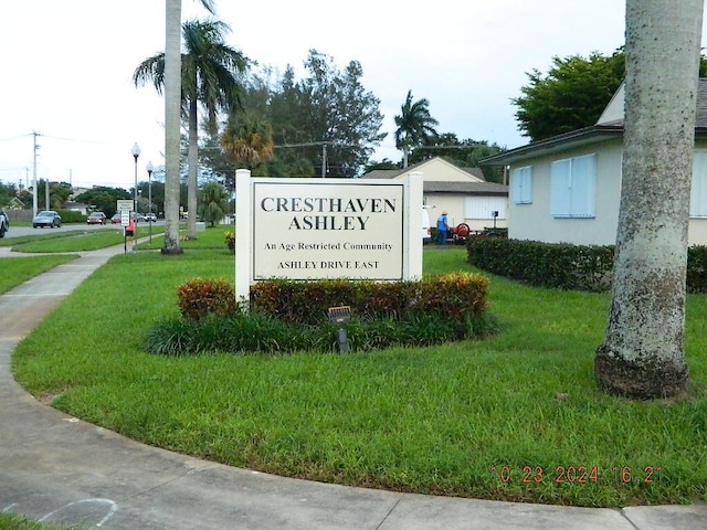 community sign featuring a lawn