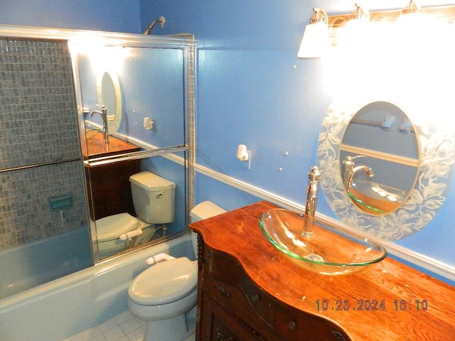 full bathroom with tile patterned floors, vanity, enclosed tub / shower combo, and toilet