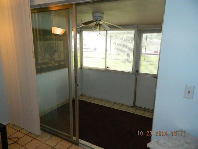 unfurnished sunroom with ceiling fan and plenty of natural light