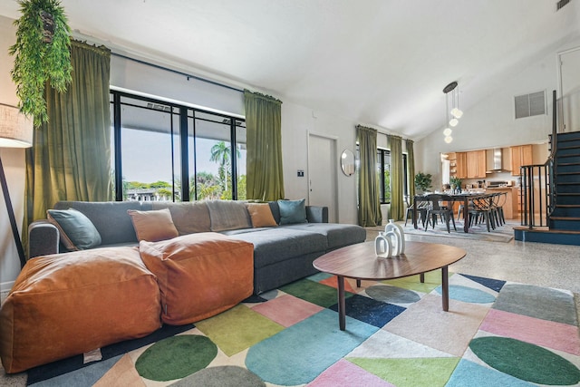 living room featuring high vaulted ceiling