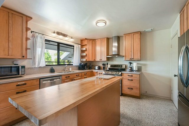 kitchen featuring butcher block counters, sink, stainless steel appliances, wall chimney range hood, and a kitchen island