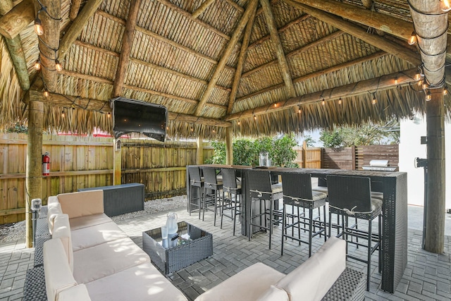 view of patio featuring a gazebo, an outdoor living space, and an outdoor bar