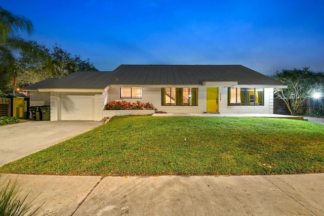 ranch-style house with a lawn and a garage