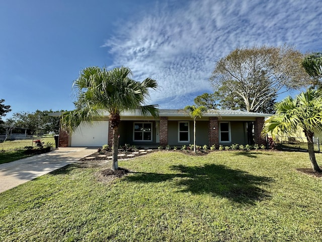 ranch-style house featuring a front yard and a garage