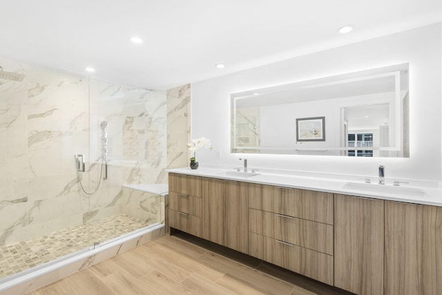 bathroom featuring a tile shower and vanity