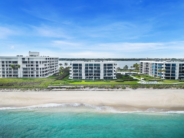 exterior space with a water view and a view of the beach