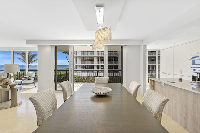 dining space featuring an inviting chandelier and floor to ceiling windows