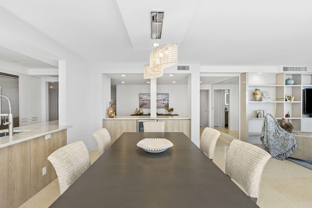 dining space featuring a notable chandelier and sink