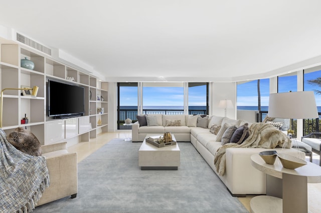 living room featuring a water view and floor to ceiling windows