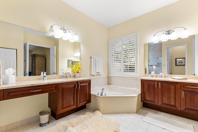 bathroom with a bathtub, vanity, and tile patterned flooring