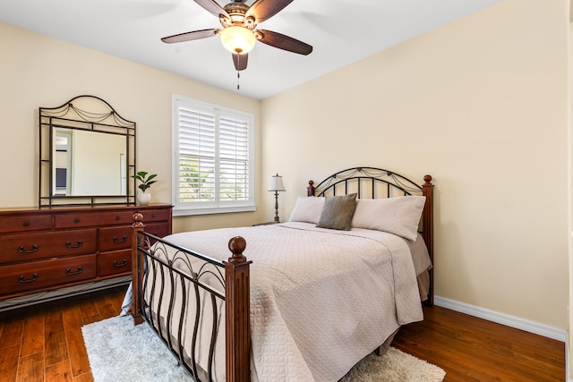 bedroom with dark wood-type flooring and ceiling fan