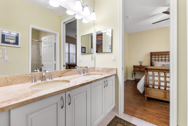 bathroom with ceiling fan, vanity, tile patterned floors, and walk in shower