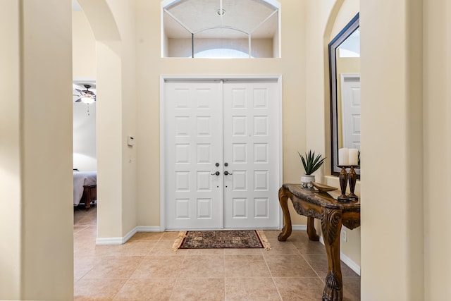 tiled entrance foyer with ceiling fan