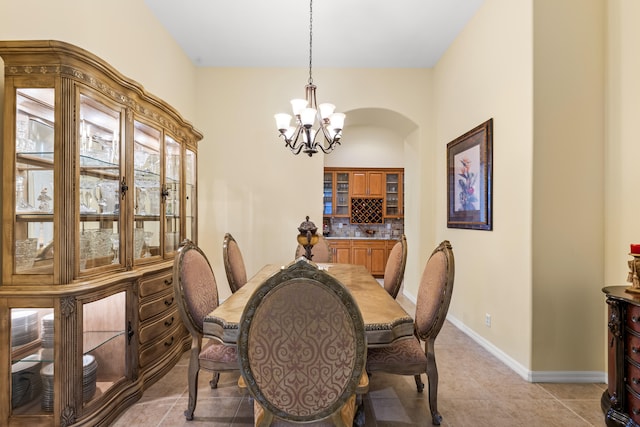 tiled dining area with an inviting chandelier