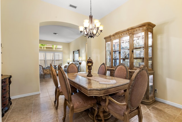 tiled dining space featuring a chandelier